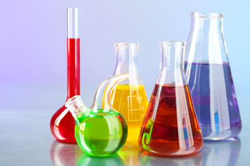 Different laboratory glassware with colorful liquid