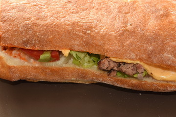 Chicken sandwitch with french fries and sauce.