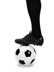 Leg of soccer player with ball on white