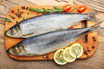 Fresh raw fish and food ingredients on table