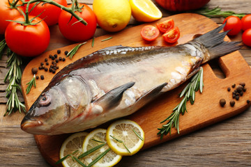 Fresh raw fish and food ingredients on table