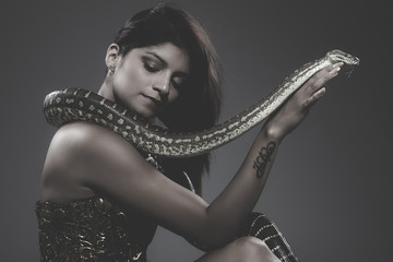 sensual beautiful latin woman with python snake