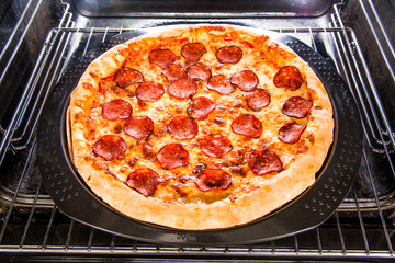 Pepperoni pizza in the oven.