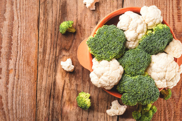 Delicious broccoli and cauliflower has a wooden rustic table