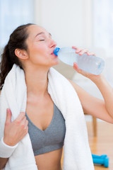 Woman drinking water after a sport session