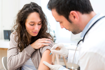 Young attractive woman being vaccinated - 72817935