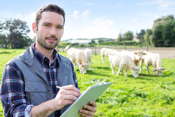 Young attractive farmer working in a field