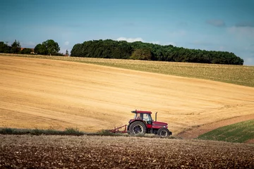 Foto op Canvas Tractor harrowing a field west of Poitiers in south western Fran © jiduha