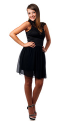 A stylish young brunette woman in black dress in little black dr