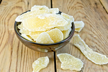 Candied ginger in bowl on board