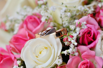 Wedding rings on a bouquet of roses