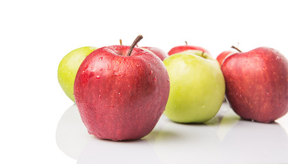 Red and green apple over white background