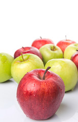 Red and green apple over white background