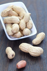 Close - up Raw dried peanut on wood table