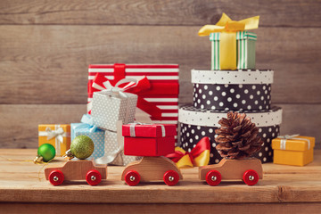 Christmas holiday concept with gift boxes on toy cars