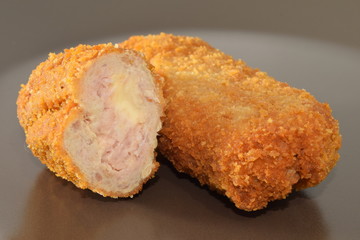 Fried chicken nuggets served on a brown plate.