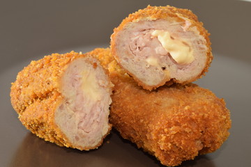 Fried chicken nuggets served on a brown plate.