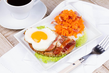 Toast with fried egg, prosciutto and pumpkin