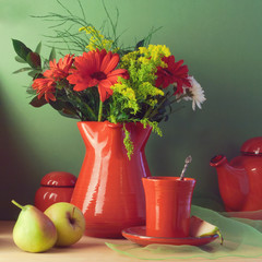 Vintage still life with red tableware, flowers and fruits