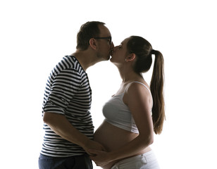 Silhouette of pregnant couple posing in studio