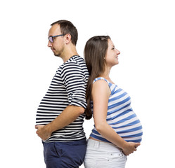 Pregnant couple posing in studio