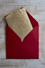 Red envelope, vintage letter, weathered white wood