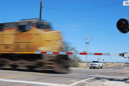 Diesel locomotive passing through railroad crossing