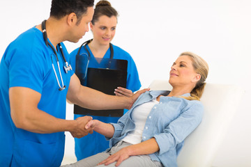 male doctor greeting senior patient before checkup