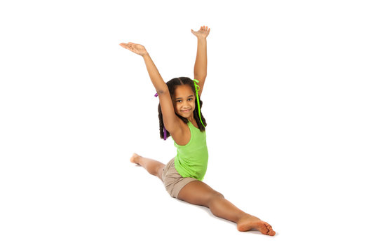 girl is engaged in gymnastics. child sitting on the splits.