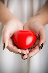 Female Hands Holding a Heart