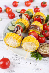 Sliced vegetables on picks on plate on table close-up