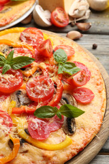 Delicious pizza served on wooden table