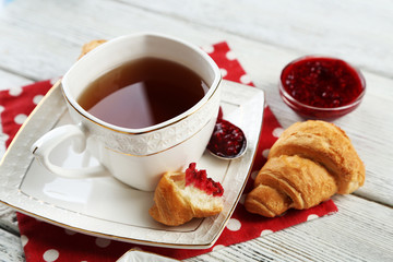 Breakfast with tea, jam and fresh croissants