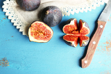 Ripe sweet figs on wooden background