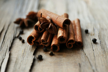 Cinnamon on wooden background, close-up