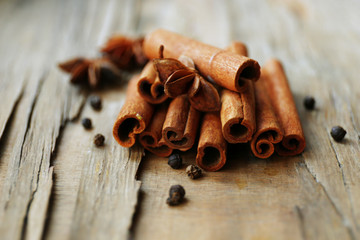 Cinnamon on wooden background, close-up