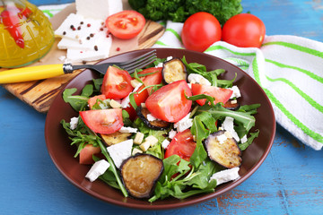 Eggplant salad with tomatoes, arugula and feta cheese,