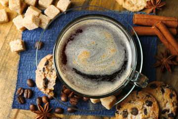 Cup of coffee and chocolate chip cookies on wooden background