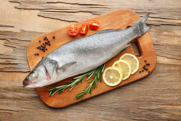 Fresh raw fish and food ingredients on table