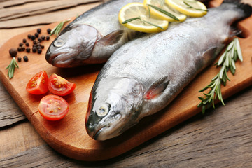 Fresh raw fish and food ingredients on table