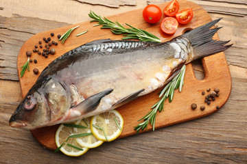 Fresh raw fish and food ingredients on table