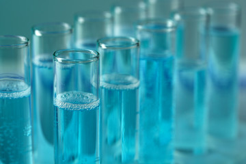 Test-tubes with liquid on color background