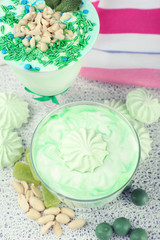 Obraz na płótnie Canvas Mint milk dessert in glass bowls on color wooden background
