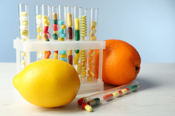 Different color drugs in test tubes and fruit, © Africa Studio
