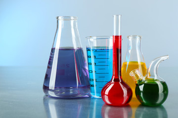 Different laboratory glassware with colorful liquid
