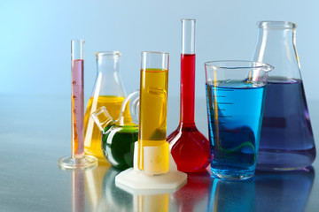 Different laboratory glassware with colorful liquid