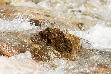 Fototapeta na wymiar Stones in the water in a river