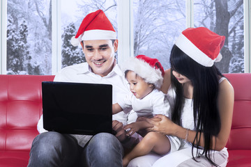 Family using laptop in christmas day