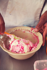 Pastry chef mixing pink frosting