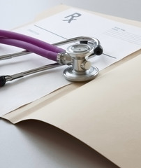 Closeup of a stethoscope on a rx prescription.